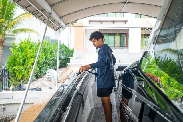 Yacht detailing at a Naples, Florida marina with palm trees in the background