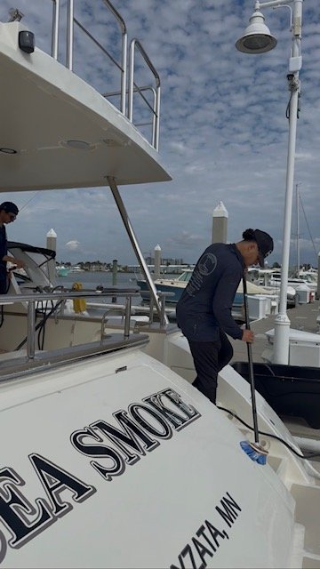 Platinum Coast Detailers team detailing the yacht Sea Smoke in Naples, Florida